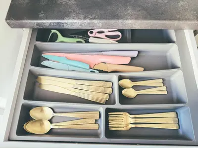 a drawer full of utensils in a refrigerator at Cozy Ozo apartments, free parking! in Vilnius