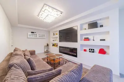 a living room with a couch and a table at Malena Apartments in Šiauliai