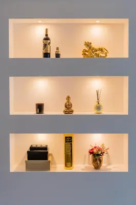a shelf with bottles and vases on it at Malena Apartments in Šiauliai