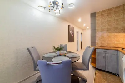 a dining room with a table and chairs at Malena Apartments in Šiauliai