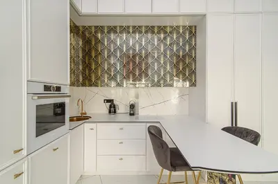 a kitchen with white cabinets and a white counter top at Apartment Gedimino 22 in Vilnius
