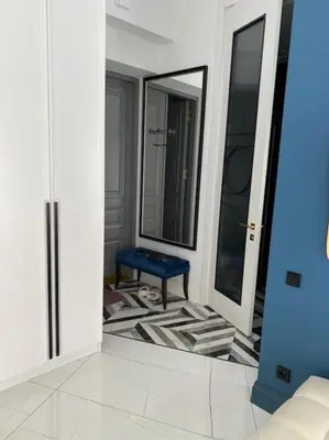 a living room with a blue bench and mirrors at Apartment Gedimino 22 in Vilnius