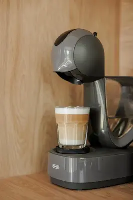 a coffee maker is making a cup of coffee at Vienis glamping - cozy and private forest house in Randamonys