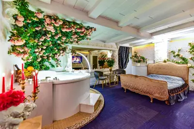 a bathroom with a tub and a flower wall at HOST apartment 3 in Kaunas