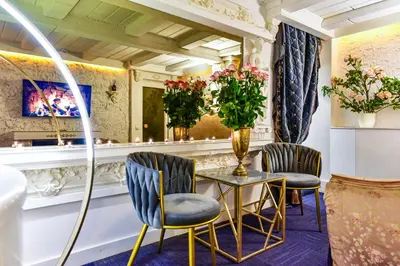 a salon with two chairs and a table and a mirror at HOST apartment 3 in Kaunas
