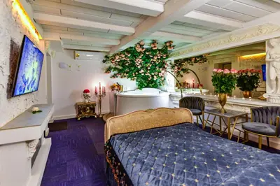 a bedroom with a bed and a dining room with plants at HOST apartment 3 in Kaunas