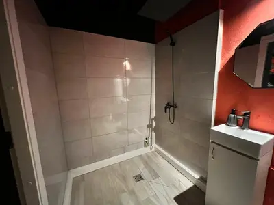 a bathroom with a shower and a sink at FETISH Room in Kaunas