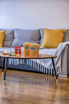 a coffee table with baskets on it in front of a couch at Family Oasis Apartments x Free parking x SELF CHECK IN 24x7 in Vilnius