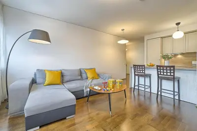 a living room with a couch and a table at Family Oasis Apartments x Free parking x SELF CHECK IN 24x7 in Vilnius