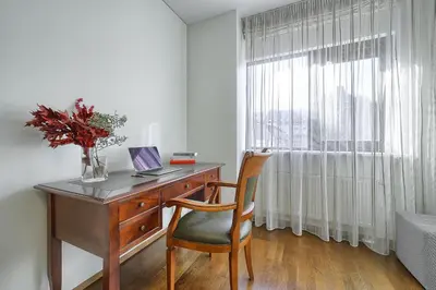 a desk with a laptop on it next to a window at Family Oasis Apartments x Free parking x SELF CHECK IN 24x7 in Vilnius