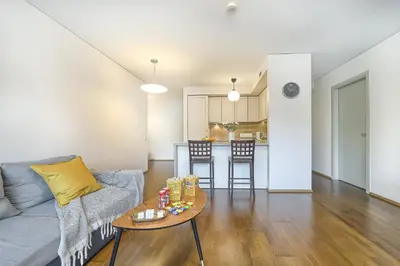 a living room with a couch and a table at Family Oasis Apartments x Free parking x SELF CHECK IN 24x7 in Vilnius