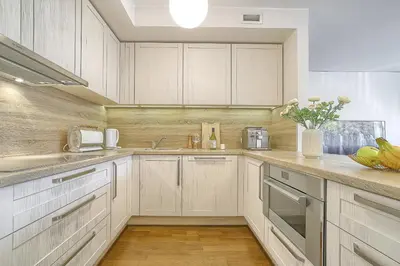 a kitchen with white cabinets and a counter top at Family Oasis Apartments x Free parking x SELF CHECK IN 24x7 in Vilnius
