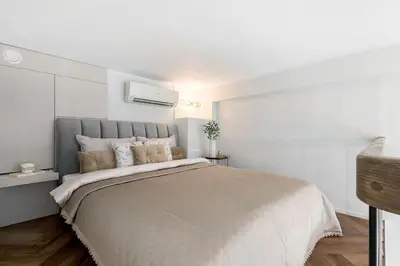 a white bedroom with a large bed in it at Vega - Whirlpool - Self Checkin in Vilnius
