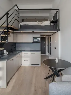a kitchen with a table and a loft bed at Modern loft in City centre Self check-in No 45 in Vilnius