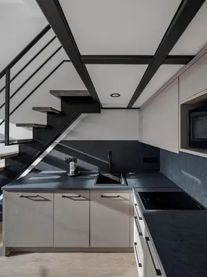 a kitchen with a sink and a staircase at Modern loft in City centre Self check-in No 45 in Vilnius