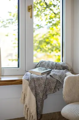 a table with a book on it next to a window at cohost I Brand New Apt, w-AC in a Central Location in Vilnius