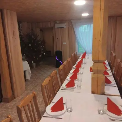a long table with red napkins on it in a room at Sodyba Po klevais in Meištai