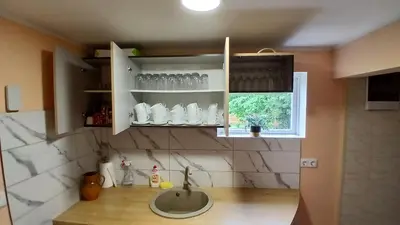 a kitchen with a sink and a window at Sodyba Po klevais in Meištai