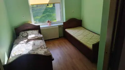 a small room with two beds and a window at Sodyba Po klevais in Meištai