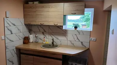 a bathroom with a sink and a window at Sodyba Po klevais in Meištai