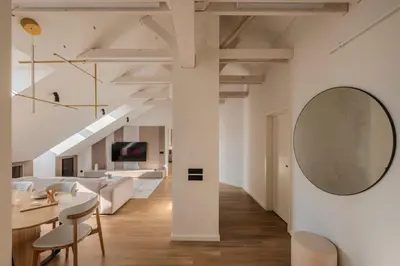 a living room with a table and a large mirror at ᴄᴏʜᴏsᴛ I 2BD Penthouse Luxury-Designer Apt, CityCenter in Kaunas