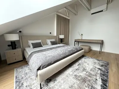 a bedroom with a large bed and a desk at ᴄᴏʜᴏsᴛ I 2BD Penthouse Luxury-Designer Apt, CityCenter in Kaunas