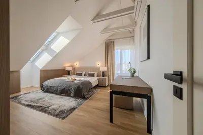 a bedroom with a bed and a desk at ᴄᴏʜᴏsᴛ I 2BD Penthouse Luxury-Designer Apt, CityCenter in Kaunas