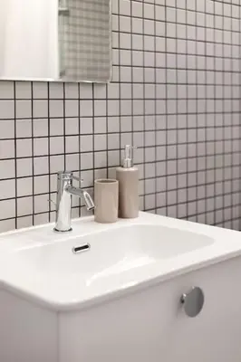 a white bathroom sink with two toilets on it at Artsy Design Loft - Hip District Uptown Vilnius in Vilnius