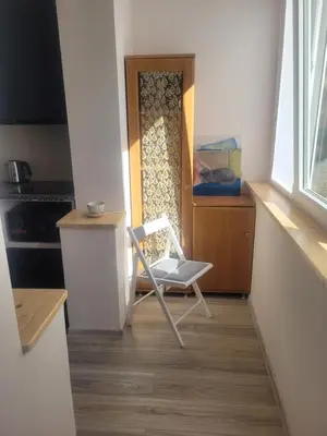 a white chair sitting in front of a door at Cozy apartment Akropolis in Vilnius