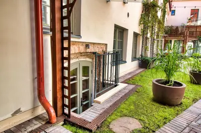 a building with a glass door in a yard at Historic & modern Arch-Studio - ArcLoft07 in Vilnius