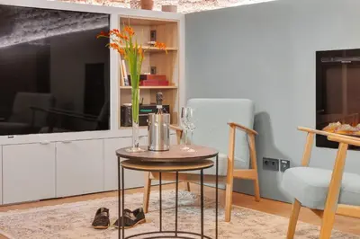 a small table with a vase on it with a vase at Historic & modern Arch-Studio - ArcLoft07 in Vilnius