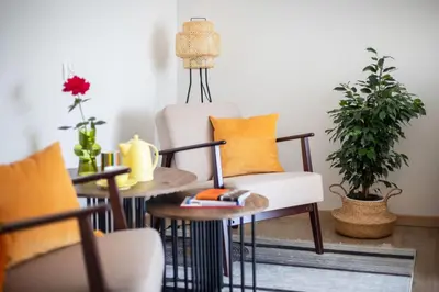 a living room with a chair and a table at Spirit Of 70s Apartment in Vilnius
