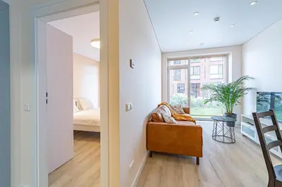 a room with a couch and a bed and a window at River Park Apartment in Kaunas
