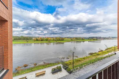 a view of a river from a building at River Park Apartment in Kaunas