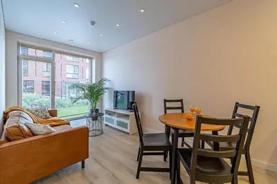 a living room with a table and a couch at River Park Apartment in Kaunas