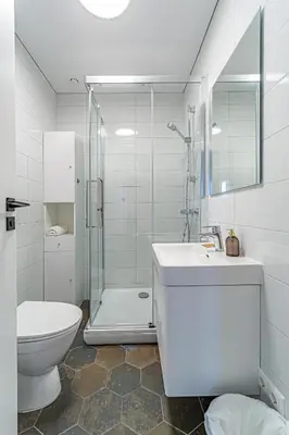 a bathroom with a toilet and a sink and a shower at River Park Apartment in Kaunas