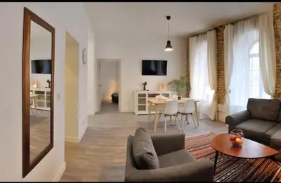 a living room with a couch and a table at Happy Inn Lux apartment, self Check, parking, Tilto str in Vilnius
