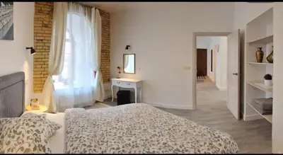 a white bedroom with a bed and a fireplace at Happy Inn Lux apartment, self Check, parking, Tilto str in Vilnius