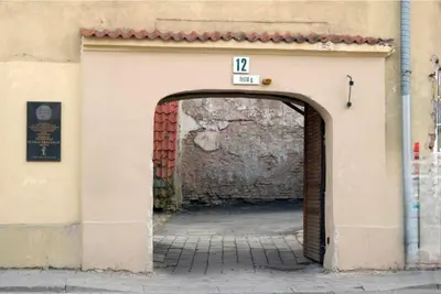 an archway into a building with a sign on it at Happy Inn Lux apartment, self Check, parking, Tilto str in Vilnius