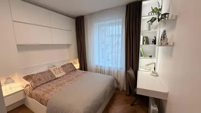 a bedroom with a bed and a desk and a window at Modern 1-Bedroom Apartment in Kaunas Downtown in Kaunas