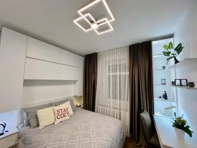 a bedroom with a bed with a white bedspread at Modern 1-Bedroom Apartment in Kaunas Downtown in Kaunas