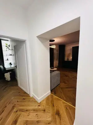 a room with white walls and wooden floors at Modern 1-Bedroom Apartment in Kaunas Downtown in Kaunas