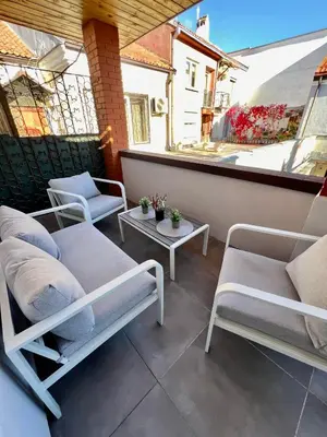 a patio with chairs and a table on a balcony at Modern 1-Bedroom Apartment in Kaunas Downtown in Kaunas