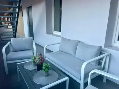 a living room with a couch and two chairs and a table at Modern 1-Bedroom Apartment in Kaunas Downtown in Kaunas