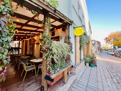 a restaurant with tables and chairs outside of a building at Modern 1-Bedroom Apartment in Kaunas Downtown in Kaunas