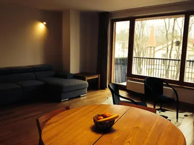 a living room with a table with a bowl of fruit on it at Apartment in Druskininkai Lithuania in Druskininkai