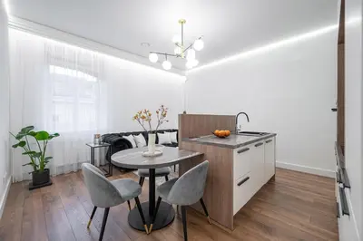 a kitchen with a table and chairs in a room at Modern Apartment in the heart of Vilnius Old Town with free parking by URBAN RENT in Vilnius