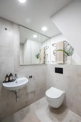 a bathroom with a sink and a toilet and a mirror at Modern Apartment in the heart of Vilnius Old Town with free parking by URBAN RENT in Vilnius