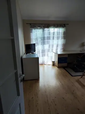 an empty room with a desk and a window at HOMESTAY ,,Aurora,, in Vilnius