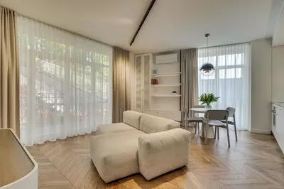 a living room with a couch and a table at Sunrise Uzupis Apartment in Vilnius